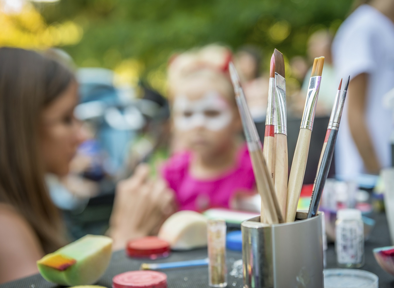 Face painting at an outdoor event.